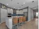 Well-lit kitchen boasts an island with seating, stainless steel appliances, and ample cabinet space at 8726 Backshore Ln, Parrish, FL 34219
