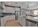 Well-equipped kitchen with stainless steel appliances, an island, and light countertops at 8726 Backshore Ln, Parrish, FL 34219
