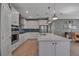 Well-equipped kitchen with stainless steel appliances, white cabinetry, and a center island at 8726 Backshore Ln, Parrish, FL 34219