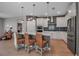 Bright kitchen features a large island with bar seating, stainless steel appliances, and stylish backsplash at 8726 Backshore Ln, Parrish, FL 34219
