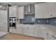 Well-equipped kitchen boasts stainless steel appliances, including built-in oven and cooktop with a stylish backsplash at 8726 Backshore Ln, Parrish, FL 34219