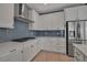 Kitchen features stainless steel appliances, modern cabinets and hardware, and stylish subway tile backsplash at 8726 Backshore Ln, Parrish, FL 34219