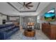 Spacious living room seamlessly connecting to dining area and kitchen, with modern furnishings and decor at 8726 Backshore Ln, Parrish, FL 34219