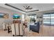 Spacious living room with lots of natural light, comfortable seating, and serene waterfront views beyond the lanai at 8726 Backshore Ln, Parrish, FL 34219