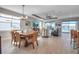 Open-concept living room and dining area with stylish furnishings and abundant natural light at 8726 Backshore Ln, Parrish, FL 34219