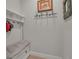 Mudroom features a built-in bench with coat hooks and shelf at 8726 Backshore Ln, Parrish, FL 34219
