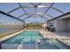 Enclosed pool area with pool, jacuzzi and a view of the water at 8726 Backshore Ln, Parrish, FL 34219