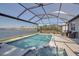Enclosed pool featuring a spa and lake views at 8726 Backshore Ln, Parrish, FL 34219