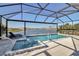 A screened-in pool features a spa with lovely lake and fountain views at 8726 Backshore Ln, Parrish, FL 34219