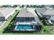 Aerial view of a screened-in pool area in a beautifully landscaped backyard at 8726 Backshore Ln, Parrish, FL 34219