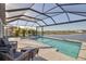 Enclosed pool with lake view features a spa, and seating at 8726 Backshore Ln, Parrish, FL 34219