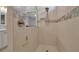 Modern shower with tiled walls, a showerhead, and a sleek glass partition for a clean and stylish look at 8726 Backshore Ln, Parrish, FL 34219