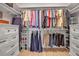Spacious walk-in closet with ample storage, shelving, and organization for clothes, shoes, and accessories at 8726 Backshore Ln, Parrish, FL 34219