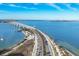 Stunning aerial view of a coastal highway, bridge, and a picturesque waterfront at 111 S Pineapple Ave # 804, Sarasota, FL 34236