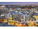 Nighttime aerial view of stylish condo building with city lights twinkling in background at 111 S Pineapple Ave # 804, Sarasota, FL 34236