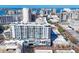 A picturesque aerial view of a modern condo, showcasing its urban setting, balconies, and distinctive architectural design at 111 S Pineapple Ave # 804, Sarasota, FL 34236
