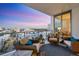Relaxing condo balcony with wicker furniture and city views at sunset at 111 S Pineapple Ave # 804, Sarasota, FL 34236