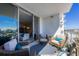 Outdoor patio with comfortable seating, overlooking skyline and sliding glass doors to living room at 111 S Pineapple Ave # 804, Sarasota, FL 34236