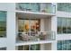 Condo balcony view features glass railings, cozy seating, and city views at 111 S Pineapple Ave # 804, Sarasota, FL 34236