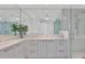 Modern bathroom with double sinks, sleek vanity, large mirrors, and glass-enclosed shower at 111 S Pineapple Ave # 804, Sarasota, FL 34236