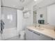 Clean bathroom featuring marble-look tile, a bathtub with shower, and a modern vanity at 111 S Pineapple Ave # 804, Sarasota, FL 34236
