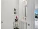 Elegant powder room features a pedestal sink, round mirror and decorative wall art at 111 S Pineapple Ave # 804, Sarasota, FL 34236