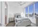 Inviting bedroom with a ceiling fan and a large window, showcasing a beautiful city view at 111 S Pineapple Ave # 804, Sarasota, FL 34236