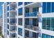 Close up view of a modern condominium showcasing multiple private balconies with glass railings and outdoor seating arrangements at 111 S Pineapple Ave # 804, Sarasota, FL 34236