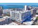 Daytime exterior view showcasing a modern condo building with balconies and vibrant street-level murals at 111 S Pineapple Ave # 804, Sarasota, FL 34236