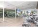 Modern gym with spin bikes, floor to ceiling mirror, and large screen for entertainment at 111 S Pineapple Ave # 804, Sarasota, FL 34236