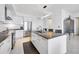 Sleek condo kitchen with modern stainless steel appliances, a center island, and white cabinetry at 111 S Pineapple Ave # 804, Sarasota, FL 34236