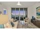Cozy living room with sliding glass doors and city views at sunset at 111 S Pineapple Ave # 804, Sarasota, FL 34236