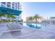 Luxury pool deck with lounge chairs and umbrellas at a high-rise condo building at 111 S Pineapple Ave # 804, Sarasota, FL 34236
