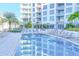 Sparkling pool surrounded by lush landscaping and comfortable lounge seating, providing a serene oasis at 111 S Pineapple Ave # 804, Sarasota, FL 34236
