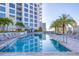 Luxurious condominium swimming pool featuring ample lounge seating, tropical landscaping, and pristine sunlit waters at 111 S Pineapple Ave # 804, Sarasota, FL 34236
