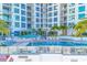 Expansive condominium pool and deck with lounge chairs, shaded seating areas, and lush landscaping for ultimate relaxation at 111 S Pineapple Ave # 804, Sarasota, FL 34236