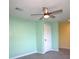 Comfortable bedroom featuring stylish ceiling fan, fresh paint, tile floor, and natural lighting at 11337 Pineapple Rd, Punta Gorda, FL 33955