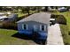 Aerial view of a single-story house with gray siding, white trim, landscaped yard, and private driveway at 11337 Pineapple Rd, Punta Gorda, FL 33955
