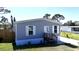 Charming single-story home with gray siding, white trim, front door, and landscaped front yard at 11337 Pineapple Rd, Punta Gorda, FL 33955