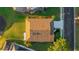 Aerial view of a single-Gathering home with a brown roof, concrete driveway, and lush landscaping at 11371 Perico Isle Cir, Bradenton, FL 34209