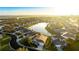 Aerial view of a home in a community with a pond at 11371 Perico Isle Cir, Bradenton, FL 34209