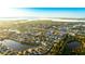 An aerial view showing the property surrounded by community homes, landscaping, and waterways at 11371 Perico Isle Cir, Bradenton, FL 34209