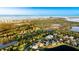 An aerial view of community homes, landscaping, and coastal views showcase the property and serene surroundings at 11371 Perico Isle Cir, Bradenton, FL 34209