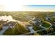 Aerial view of house showcases neighborhood, pond views, and mature landscaping at 11371 Perico Isle Cir, Bradenton, FL 34209