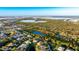 An aerial view of homes, landscaping, and waterfront views showcase the property and serene surroundings at 11371 Perico Isle Cir, Bradenton, FL 34209
