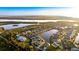 Wide aerial view of community homes, landscaping, and lake views showcasing the property and its serene surroundings at 11371 Perico Isle Cir, Bradenton, FL 34209