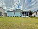 Charming home featuring a well-maintained lawn and a cozy screened-in porch at 11371 Perico Isle Cir, Bradenton, FL 34209