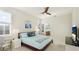 Comfortable bedroom with a queen bed, plantation shutters, ceiling fan, and ensuite bathroom access at 11371 Perico Isle Cir, Bradenton, FL 34209