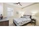 Cozy bedroom with nautical decor, plantation shutters, and a modern ceiling fan at 11371 Perico Isle Cir, Bradenton, FL 34209