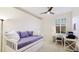 Bedroom features a daybed, ceiling fan, and dedicated desk space for work or study at 11371 Perico Isle Cir, Bradenton, FL 34209